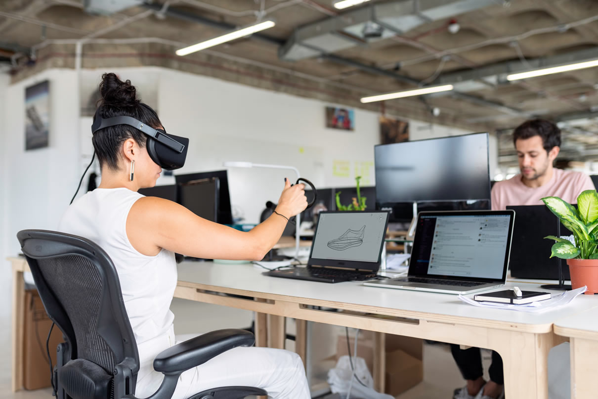woman-in-white-tank-top-using-black-laptop-computer-with-vr-3861458